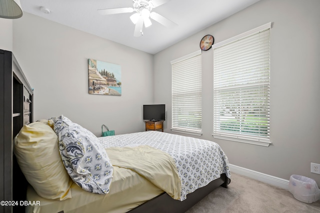 bedroom with light carpet and ceiling fan