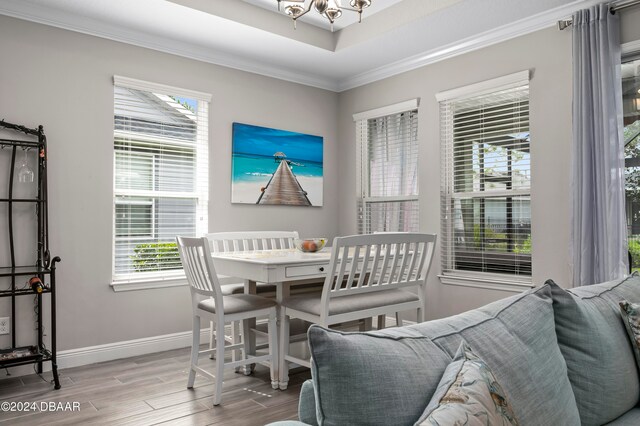 dining area featuring hardwood / wood-style flooring and ornamental molding