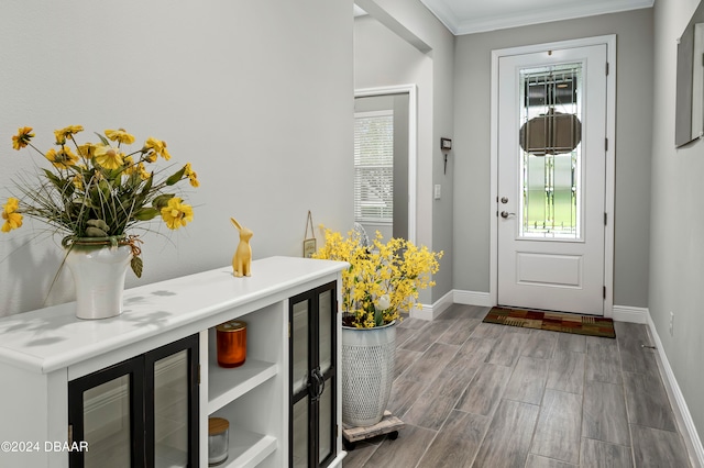 entrance foyer with hardwood / wood-style flooring, crown molding, and wine cooler