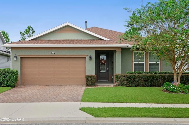 single story home with a front yard and a garage