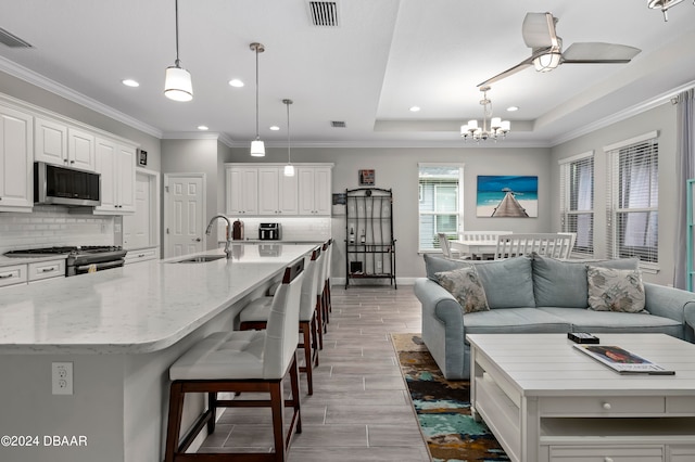 kitchen with a spacious island, decorative light fixtures, and stainless steel appliances