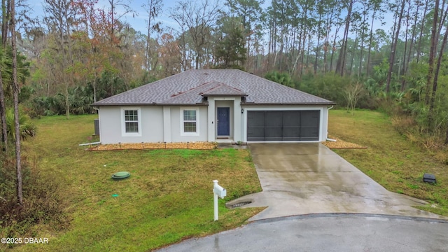 view of front of property with a garage, driveway, a front lawn, and a shingled roof