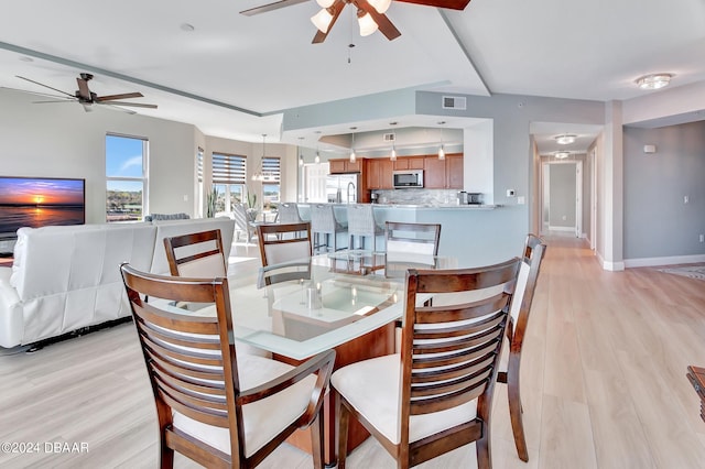 dining room with light wood-type flooring and ceiling fan