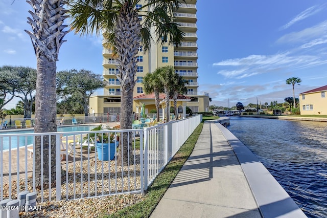 exterior space featuring a water view and a community pool