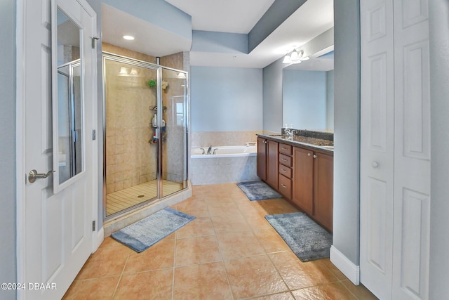 bathroom with vanity, plus walk in shower, and tile patterned flooring