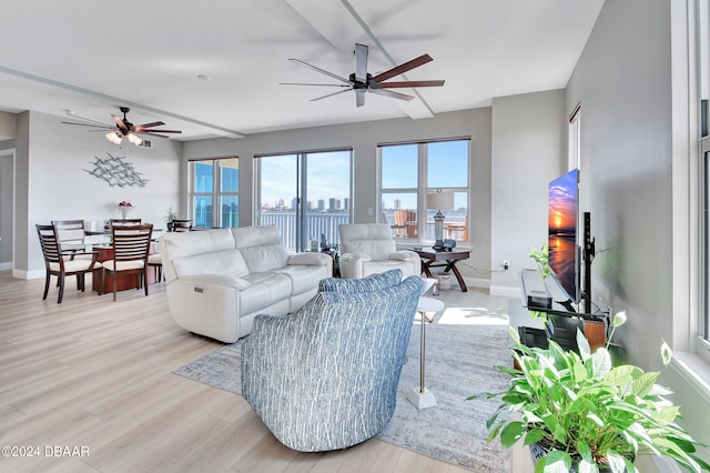 living room featuring ceiling fan and light hardwood / wood-style flooring