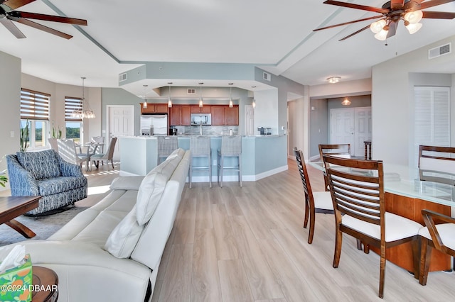 2801 S Ridgewood Ave Unit 608, South Daytona, FL 32119 - living room featuring ceiling fan, light wood-type flooring, baseboards, and a chandelier
