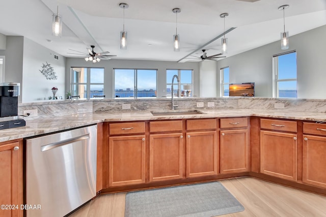 kitchen with sink, light wood-type flooring, dishwasher, and decorative light fixtures