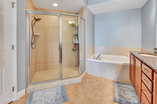 bathroom featuring independent shower and bath, vanity, and tile patterned floors