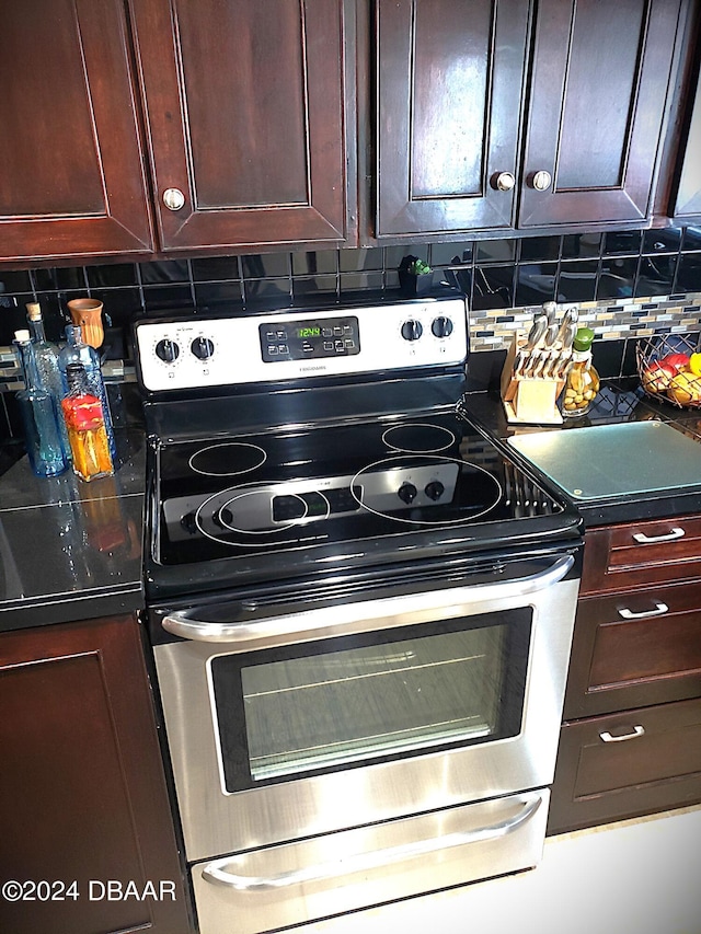 kitchen featuring backsplash and stainless steel electric range oven