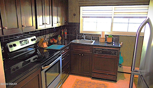 kitchen with tasteful backsplash, stainless steel appliances, sink, and dark brown cabinets