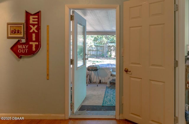 entryway with baseboards and wood finished floors