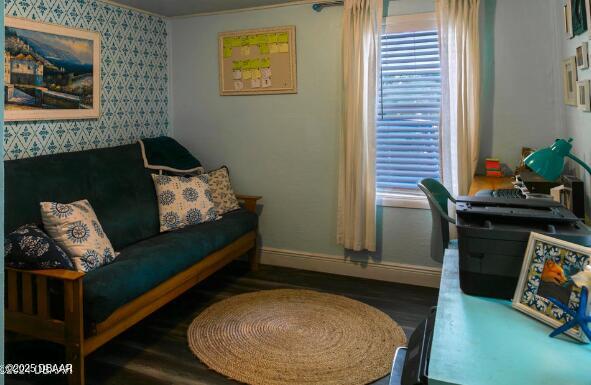 sitting room featuring baseboards and dark wood finished floors