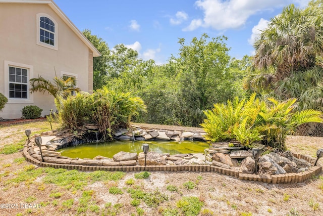 2710 Quiet Ln, Cocoa, FL 32926 - view of yard featuring a garden pond