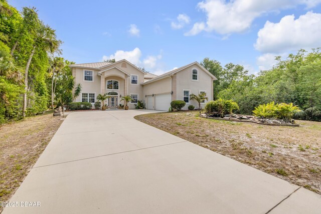 2710 Quiet Ln, Cocoa, FL 32926 - view of front of property featuring a garage, stucco siding, and concrete driveway
