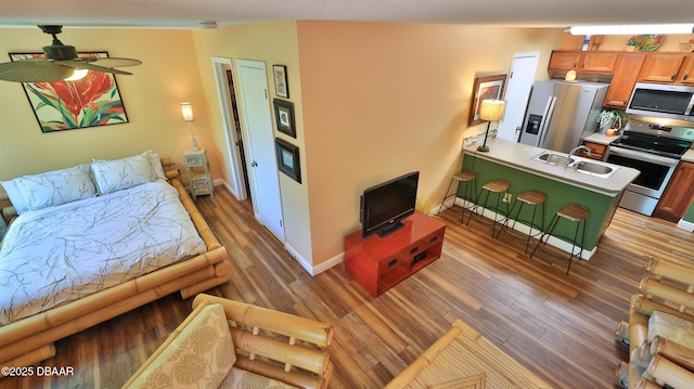 1401 S Palmetto Ave Unit 402, Daytona Beach, FL 32114 - living room with light wood-style floors and ceiling fan