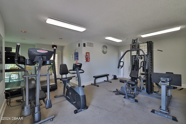 workout area featuring a textured ceiling