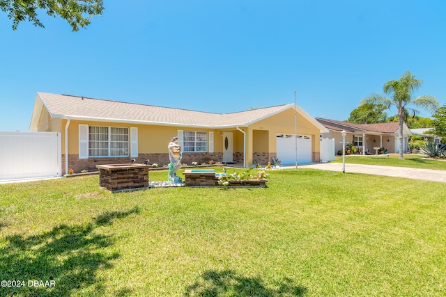 ranch-style house featuring a front lawn and a garage