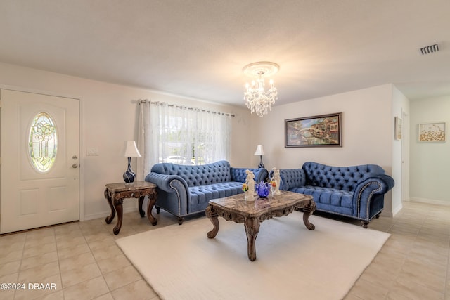 living room featuring a notable chandelier, light tile patterned floors, and plenty of natural light