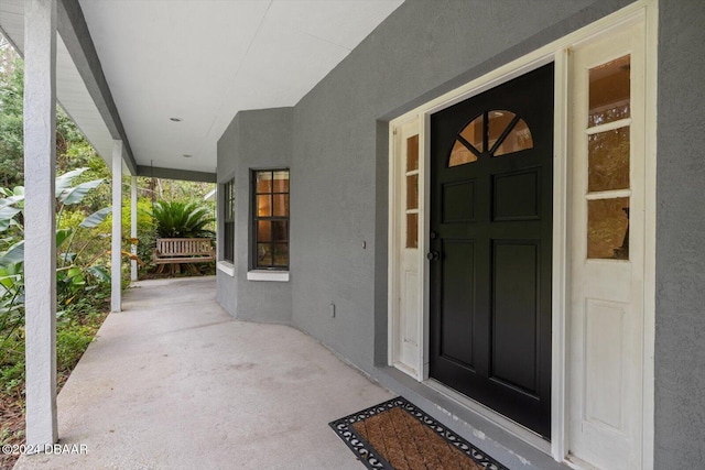 property entrance featuring a porch