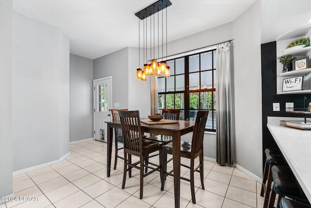 dining area featuring a notable chandelier and light tile patterned flooring