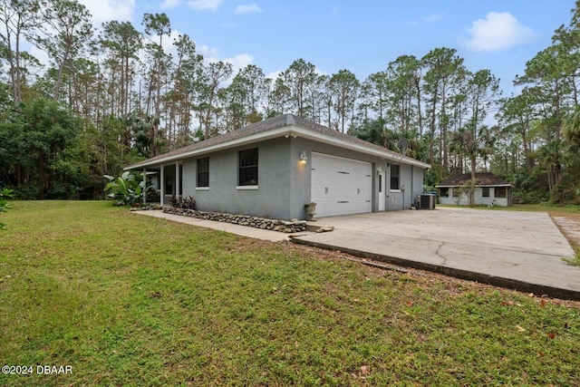 exterior space featuring a lawn and central AC