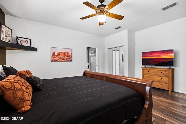 bedroom featuring a closet, dark hardwood / wood-style floors, and ceiling fan