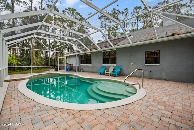 view of pool featuring a patio area and a lanai