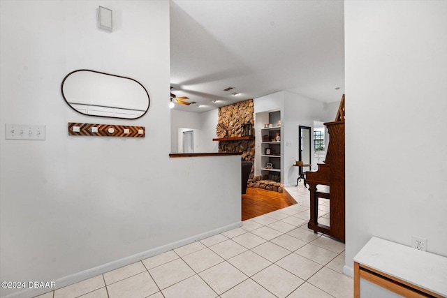 interior space with built in shelves and light tile patterned floors