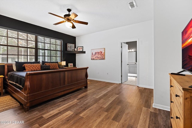 bedroom with dark hardwood / wood-style floors, ceiling fan, and connected bathroom