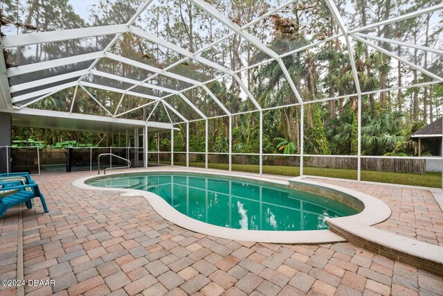 view of pool with a lanai and a patio