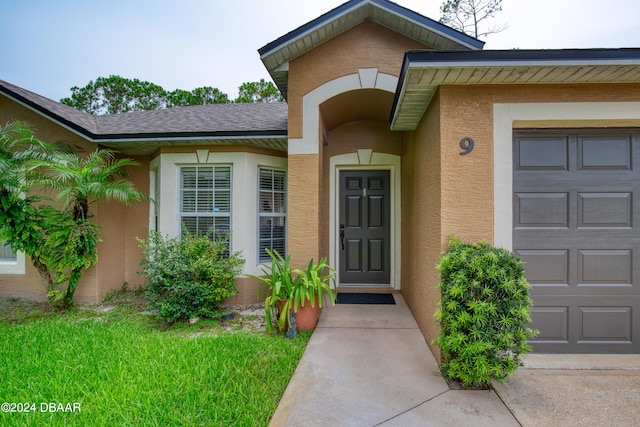 view of exterior entry featuring a garage