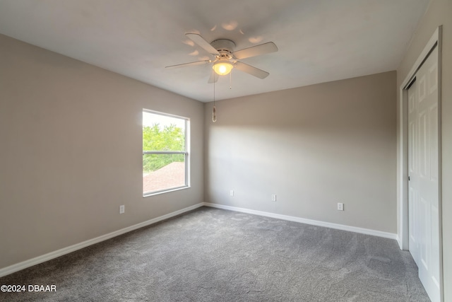 spare room featuring carpet flooring and ceiling fan