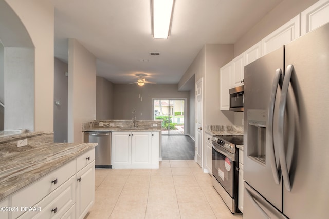 kitchen featuring white cabinets, light stone countertops, sink, and appliances with stainless steel finishes