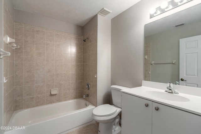 full bathroom with vanity, tile patterned flooring, tiled shower / bath, and toilet