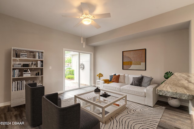 living room featuring dark hardwood / wood-style flooring and ceiling fan