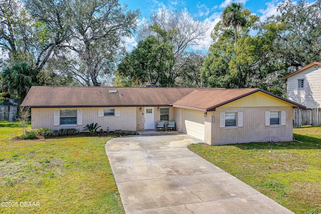 ranch-style home with a garage and a front yard