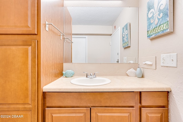 bathroom with vanity and a textured ceiling