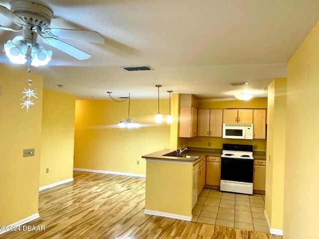 kitchen with light wood-type flooring, white appliances, light brown cabinetry, pendant lighting, and kitchen peninsula