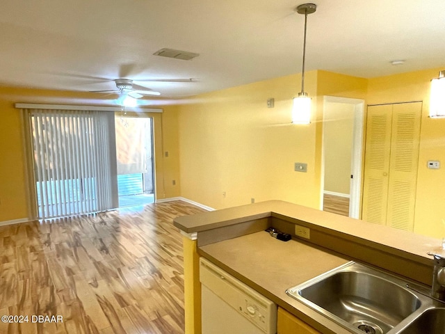 kitchen with pendant lighting, sink, dishwasher, ceiling fan, and light hardwood / wood-style flooring