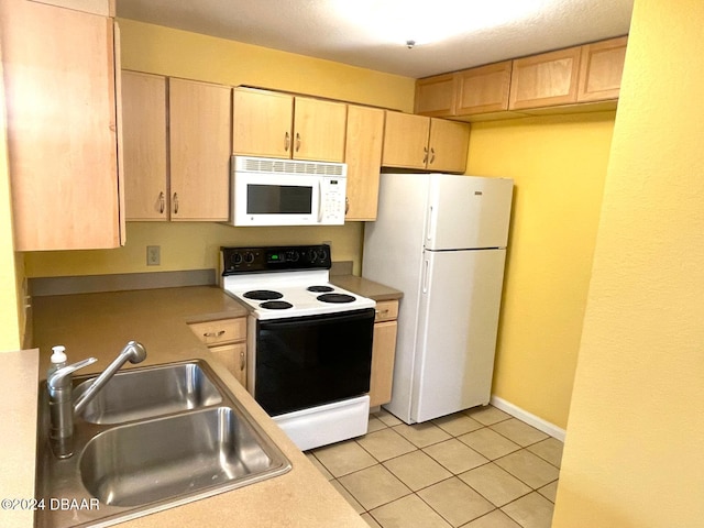 kitchen with white appliances, light brown cabinetry, sink, and light tile patterned flooring