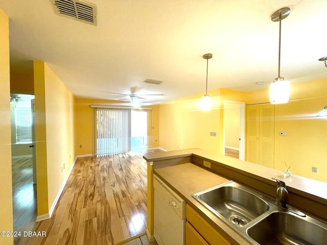 kitchen with white dishwasher, hanging light fixtures, sink, ceiling fan, and light wood-type flooring