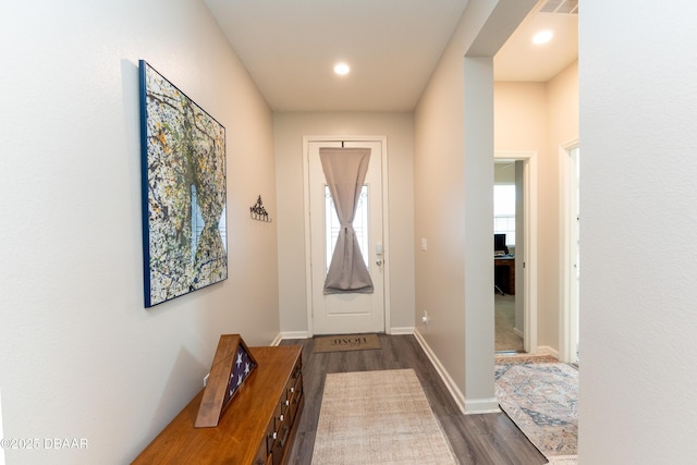 doorway with recessed lighting, dark wood-style floors, and baseboards