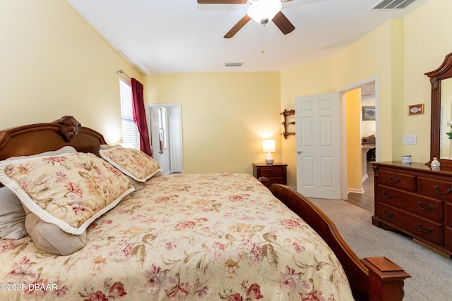 carpeted bedroom with a ceiling fan and visible vents