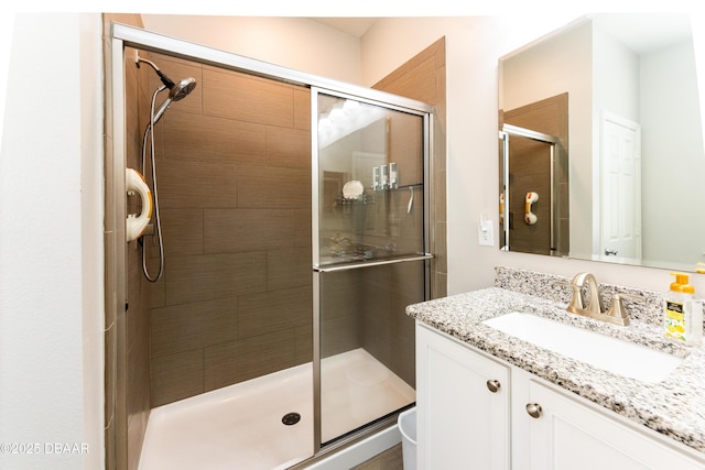 bathroom with vanity and a shower stall