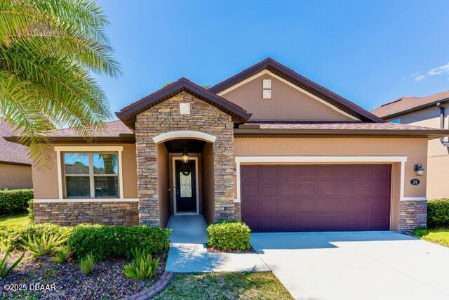 view of front of home featuring stucco siding and stone siding