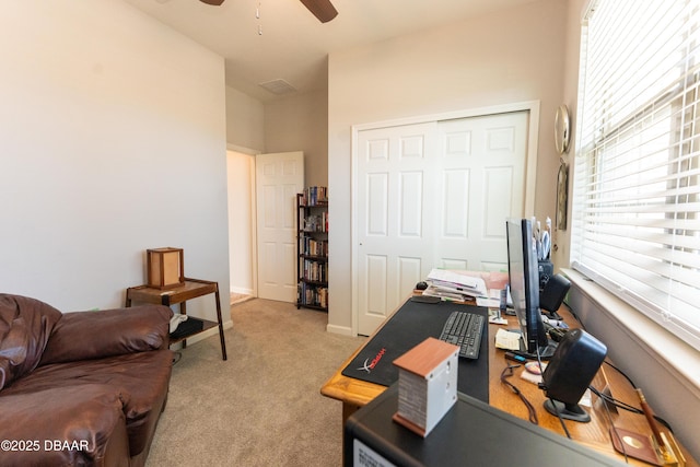 home office featuring light colored carpet, baseboards, and ceiling fan