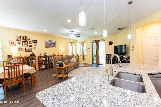 kitchen with a ceiling fan, dark wood-style floors, visible vents, a sink, and stainless steel dishwasher