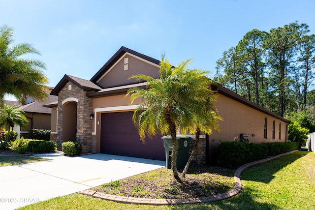 view of front of home with concrete driveway, a front yard, stucco siding, a garage, and stone siding