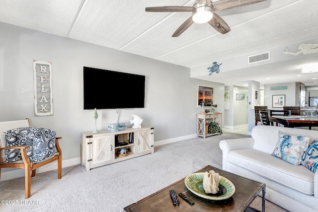 living room with ceiling fan and light colored carpet